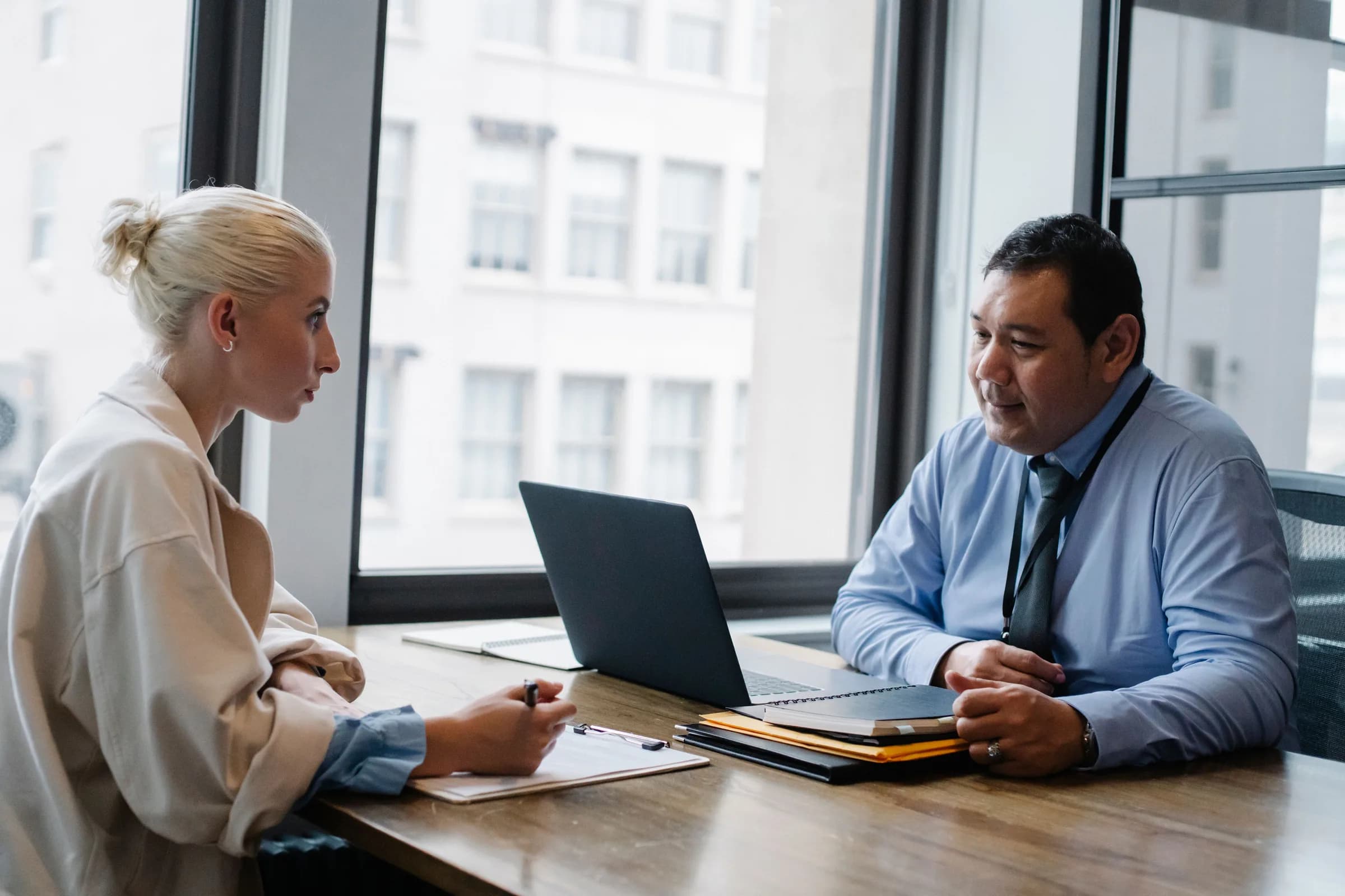 Two colleagues in conversation in a modern office